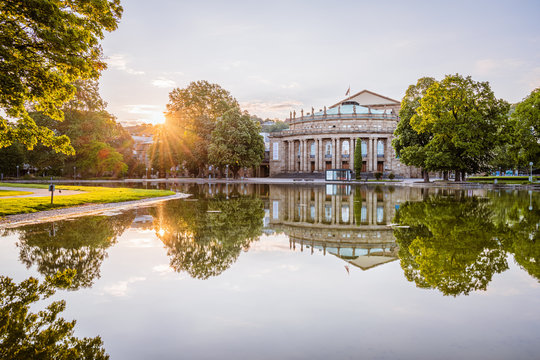 Stuttgart Opera house ("Opernhaus"), reflections of trees in lake, warm spring morning