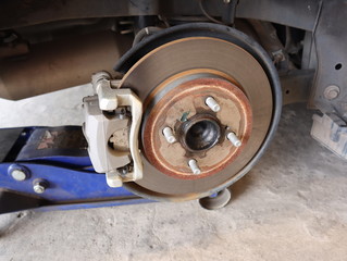 Car rear disc brake with caliper brake pad on maintenance and inspection.