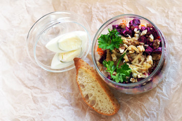 Salad of beets, eggs, herring, walnuts, herbs. Top view
