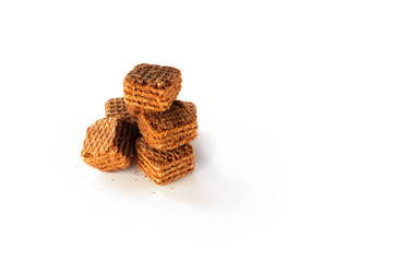 Small cubes cocoa wafers. Chocolate wafer and crumb on white background, copy space. Waffles