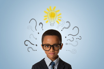 Handsome african american  little boy wearing glasses and thinking with many question marks and lightbulb. Concept of ideas