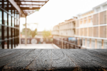 Empty wood table platform with bokeh light of city background for product presentation display montage.