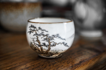 White ceramic cup with pine pattern.  Jingdezhen porcelain cup for tea ceremony. 