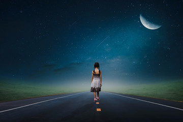 young woman walking on the road