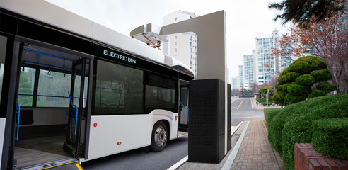 Electric bus at a charging station on a city street