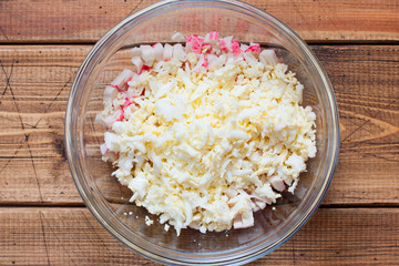 Step-by-step preparation of salad with crab sticks, tomatoes, cheese and eggs, step 2 - adding boiled eggs, top view, selective focus © Анна Журавлева