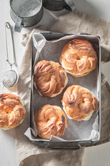 Homemade and tasty cream puffs on rustic dark table