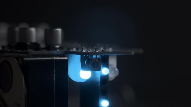 Macro View of Electronic Circuit, Microchips, 
Transistor and Capacitor on Computer Mother Board with Blinking Blue Lights. 4k