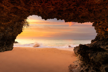 Amazing view on tropical beach from mountain cave at sunset