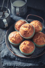 Yummy and sweet yogurt muffins on rustic dark table