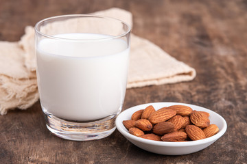 Close Up glass of Almond milk with Almond seeds. Almond milk in a glass with almonds.