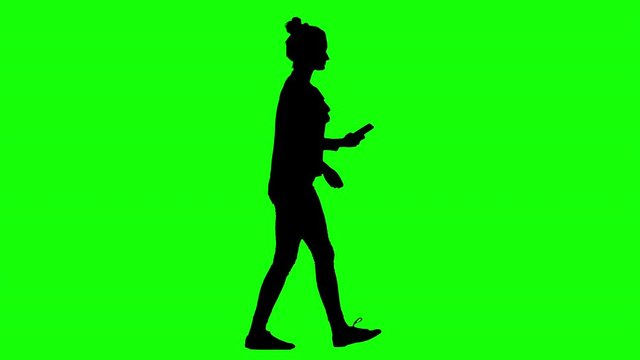 Lady Walking and Texting on Smartphone While Walking Green Screen Silhouette