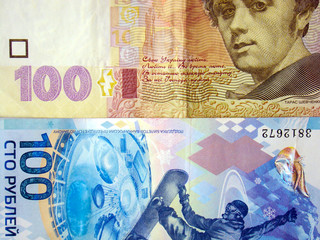 Banknotes of 100 hryvnias and 100 rubles