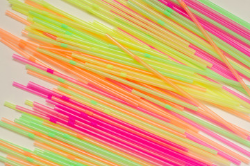 heap of multicolored plastic disposable drinking straws