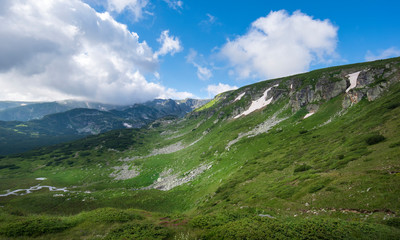 Fototapeta na wymiar Rila mountain, Bulgaria. One of the most visited nature places of tourists and top landmark. Sightseeing with green and blue colors. Panorama view