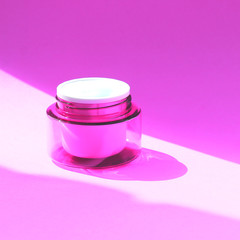 Flat lay face and body cream in a jar. Beauty background with facial cosmetic products.