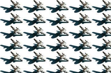 Thirty metal figures of small silver colored airplanes with shadows on the white background. Conceptual geometric art trendy pattern. Aviation industry background with rows of aircrafts
