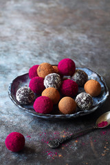 Homemade Chocolate truffles rolled in freeze-dried pitahaya, cocoa powder, ground almond and coconut flakes.
