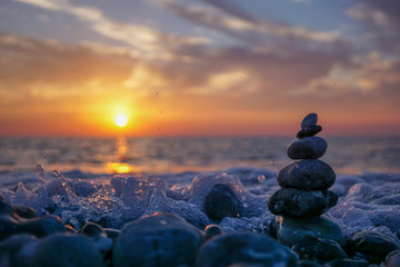 Zen stone sculpture - pebble - and calm sea at sunset near Dieppe France