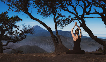 Serenity and yoga practicing, meditation near Bromo volcano in Java island