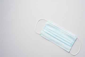 Medical mask, Medical protective mask on blue background. Disposable surgical face mask cover the mouth and nose. Healthcare and medical concept