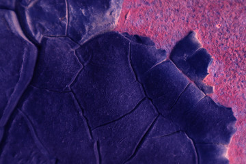 Old metal background with old molten tar, tinted blue.