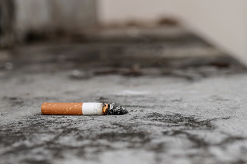 Cigarette butts on the cement floor Concept of toxic waste, not environmentally friendly.
