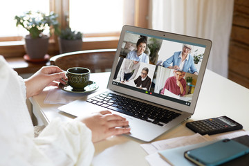Team of coworkers involved in webcam video conference call led by mature CEO, brainstorming,...