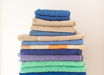 stack clean bath towels colorful cotton terry textile background. Spa and cozy home concept. copy space for text