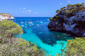 View of the small beautiful bay Cala Macarelleta with clear emerald water of the island Menorca, Balearic islands, Spain