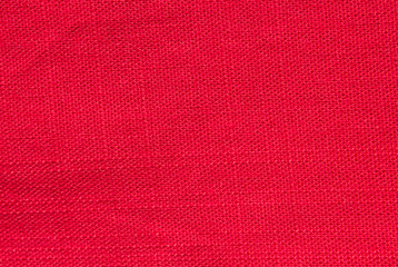red cotton texture rough fabric background natural fabric and dye, bright red color. Top view. Flat lay composition