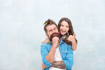 spending time together at home. little girl made funny hairstyle for daddy. daughter and dad playing together. hairstylist her future career. father enjoying time with child. togetherness