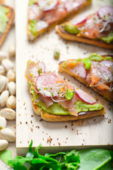 salmon toast with gacamole, radishes and bean sprouts