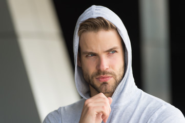 Naklejka premium His beard is unshaven. Unshaven man in hood outdoors. Handsome guy with unshaven face. Bachelor wear hoodie. Unshaven look. Barbershop. Hair salon. Mens grooming habit. Sexy boy