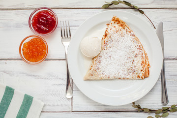 thin pancakes with jam honey and sour cream and coffee