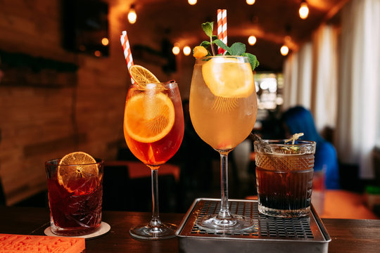 Aperol Spritz Cocktail. Alcoholic beverage based on table with ice cubes and oranges.