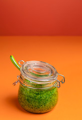Green pesto sauce in a jar. Italian pasta sauce. Homemade pesto