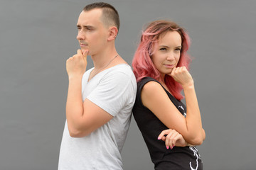 Portrait of couple thinking together against gray wall