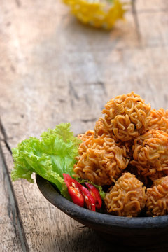 crispy noodle balls served on bowl, also known as bola bola mie