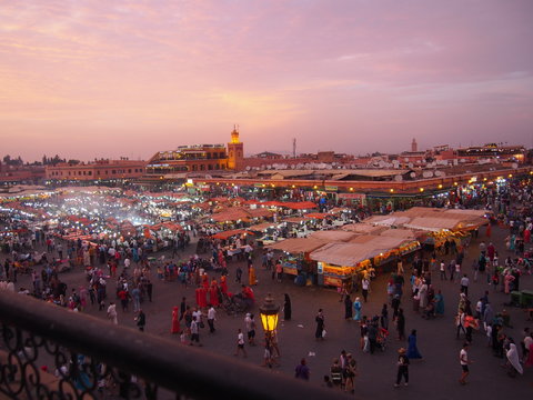A lively square with a beautiful sunset and many people, Place de Jama el Fna, Marrakech, Morocco
