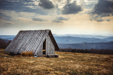 Old wooden shelter in mountain carpathian landscape Brenna Poland - obrazy, fototapety, plakaty