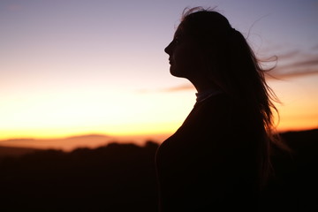 silhouette of a woman girl  in sunset fresh wind air 