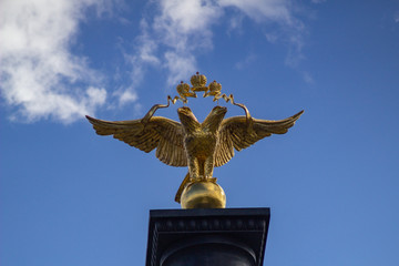 Coat of arms of the Russian Federation against the blue clear sky