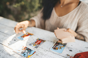 Close uo of female hands with Tarot cards