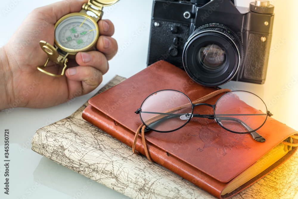 Poster old camera, notebook, map and retro compass. a concept of travel full of adventure or treasure hunti