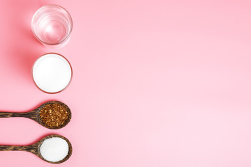 Obraz na płótnie Canvas ingredients for the preparation of Dalgon coffee: instant coffee, sugar, water, milk on a pink background