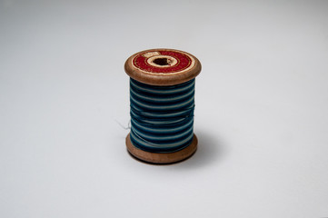 blue spool with white filaments for seamstress work