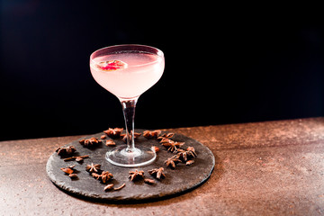 cocktail pink drink with decorations black dark background