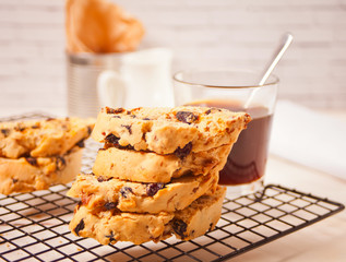 Italian biscotti on the baking rack and glass of coffee on the background