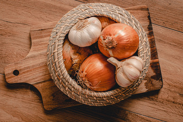 Onions and garlic on the wood